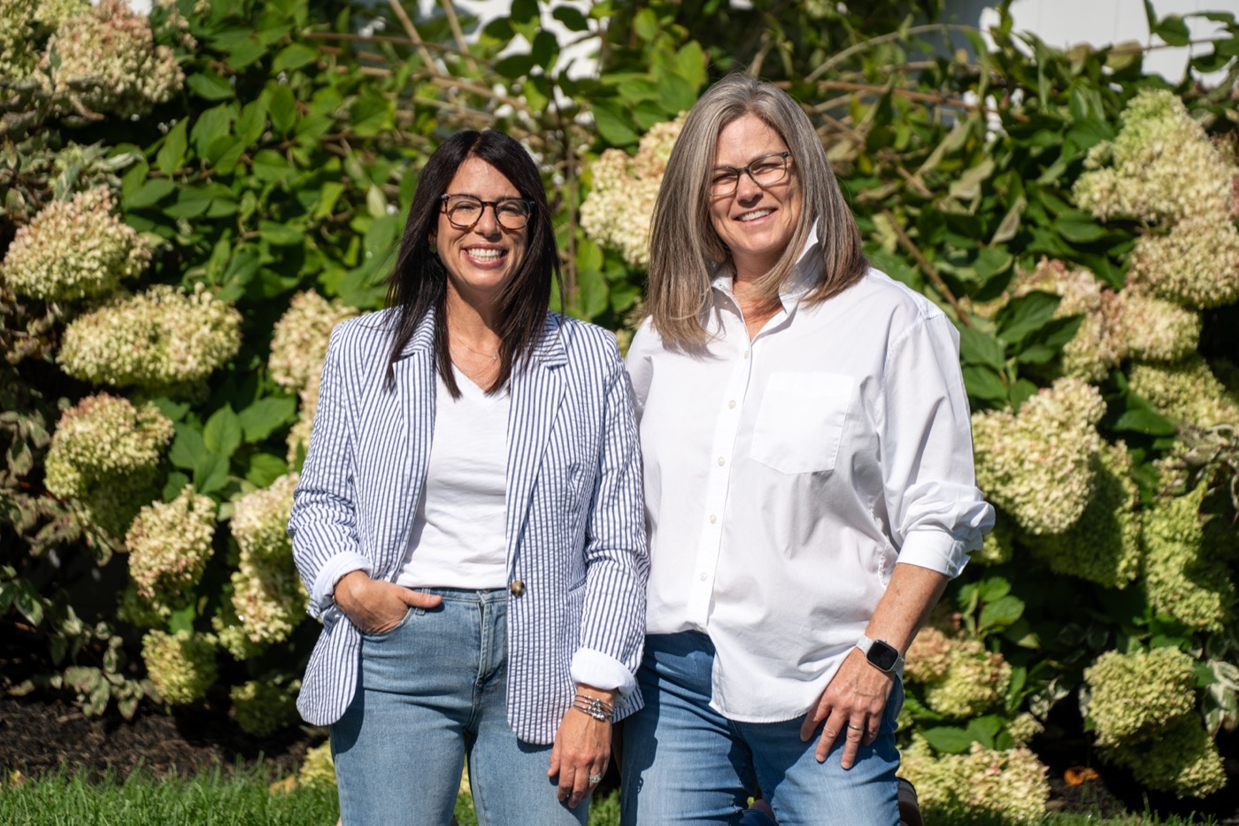 The Limelight TC team standing together in front of limelight hydrangeas